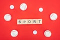 Sport Lettering On Wooden Cubes Near Softballs Isolated On Red .