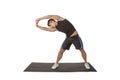 The sport man in black is doingSide Strecth. Royalty Free Stock Photo