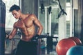 Sport man boxing in punching bag at the gym workout for healthy care and body building. Fitness instructor exercising the fitness Royalty Free Stock Photo