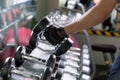 Sport man doing one-arm dumbbell rows of metal in modern gym. Royalty Free Stock Photo