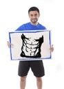 Sport man holding billboard with six pack abdomen draw advertising marketing of gym fitness club Royalty Free Stock Photo