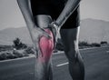 Sport man holding his knee in pain injured when running outdoors Royalty Free Stock Photo