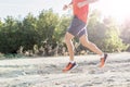 sport man with ripped athletic and muscular legs running downhill off road in jogging training workout Royalty Free Stock Photo