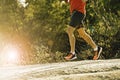 Sport man with ripped athletic and muscular legs running downhill off road in jogging training workout Royalty Free Stock Photo