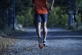 Sport man with ripped athletic and muscular legs running off road in jogging training workout at countryside in Autumn background Royalty Free Stock Photo