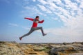Sport man running, jumping over rocks in mountain area. Royalty Free Stock Photo