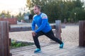 Sport man stretching aoutdoors doing exercises evening at sunset. Fitness concepts Royalty Free Stock Photo