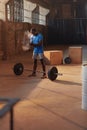 Sport man using hand chalk powder before workout at gym