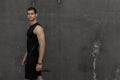 Sport model man posing gray wall background