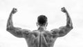 Sport motivation. Man celebrating success. Bodybuilder strong muscular back feeling powerful and superior. Achieve