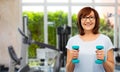 Senior woman with dumbbells exercising in gym Royalty Free Stock Photo