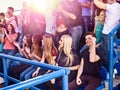 Sport olympiad fans singing on tribunes.