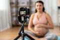 pregnant woman or yoga blogger with camera at home Royalty Free Stock Photo