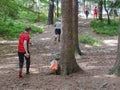 Sport people in forest checking chip with control point