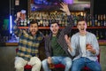 Sport, people, leisure, friendship, entertainment concept - happy male football fans or good yuong friends drinking beer Royalty Free Stock Photo