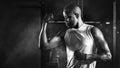 Sport portrait of african american athletics strong bodybuilder man posing show his muscle in gym in dark tone in black and white Royalty Free Stock Photo