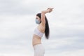 Sport during quarantine, coronavirus, covid-19. Young athletic woman wearing medical protective mask