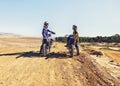 Sport, racer or relax on motorcycle outdoor on dirt road with blue sky for driving, challenge or competition. Gear