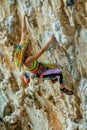 Sport rock climber girl on challenging overhanging climbing route in Kalymnos, Greece