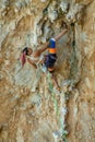 Sport rock climber woman on challenging overhanging climbing route in Kalymnos, Greece