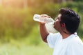 Sport runner black man wear athlete headphones he drinking water from a bottle Royalty Free Stock Photo