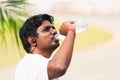 Sport runner black man wear athlete headphones he drinking water from a bottle Royalty Free Stock Photo