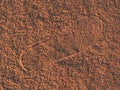 Sport shoe footprint on a tennis clay court. Dry light red surface Royalty Free Stock Photo