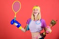 Sport shop assortment. Girl cheerful successful modern woman hold golden goblet of sport champion and equipment red Royalty Free Stock Photo