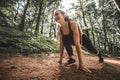 Sport smiling female athlete in start position to running outdoors Royalty Free Stock Photo