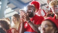 Sport Stadium Big Event: Handsome Expressive Black Man with Painted face Jumping Up and Cheering Royalty Free Stock Photo