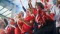 Sport Stadium Event: Crowd of Fans Cheer for their Red Soccer Team to Win. People Celebrate Scoring Royalty Free Stock Photo