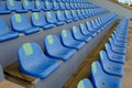 Sport stadium Plastic blue chairs in a row.