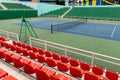 Sport stadium with several rows of spectator seating and tennis court at sport stadium or performance venue.