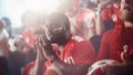 Sport Stadium Soccer Match: Diverse Crowd of Fans Cheer for their Red Team to Win. People Celebrate Royalty Free Stock Photo