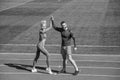 Sport success. male and female coach on stadium running track arena. healthy lifestyle. sport couple celebrate team win