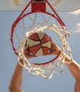 sport success. scoring while basketball game. ball goes through basket. Royalty Free Stock Photo