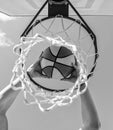sport success. scoring while basketball game. ball goes through basket. Royalty Free Stock Photo