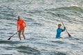 Surfers ride in sea