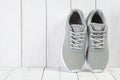 Sport symbols - gray sneakers on wooden background Royalty Free Stock Photo