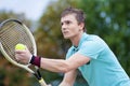 Sport and Tennis Concept: Handsome Caucasian Man With Tennis Raquet Preparing to Serve Ball On Court. Royalty Free Stock Photo