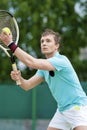 Sport and Tennis Concept: Handsome Caucasian Man With Tennis Raquet Preparing to Serve Ball On Court Royalty Free Stock Photo