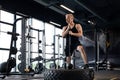 Sport training for endurance, strong man with hammer. Concept of crossfit workouts. Royalty Free Stock Photo
