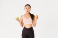 Sport, wellbeing and active lifestyle concept. Amused and wondered cute asian girl likes fitness and eating healthy food Royalty Free Stock Photo