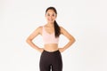 Sport, wellbeing and active lifestyle concept. Cheerful slim and strong asian fitness girl workout in gym, standing in