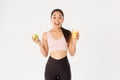 Sport, wellbeing and active lifestyle concept. Excited cute asian fitness girl, sportswoman with apple and orange juice Royalty Free Stock Photo