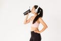 Sport, wellbeing and active lifestyle concept. Profile portrait of sexy asian fitness coach, woman in headphones