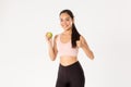 Sport, wellbeing and active lifestyle concept. Slim and healthy cute female gym coach, fitness trainer advice eating Royalty Free Stock Photo