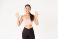 Sport, wellbeing and active lifestyle concept. Smiling strong and slim asian female fitness instructor teaching lesson Royalty Free Stock Photo