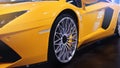 Wheels of a modern sport car. The lights of the yellow car. Modern Car exterior details. Royalty Free Stock Photo