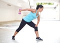 Sport woman in blue with dumbbell doing tricep back extension exercise